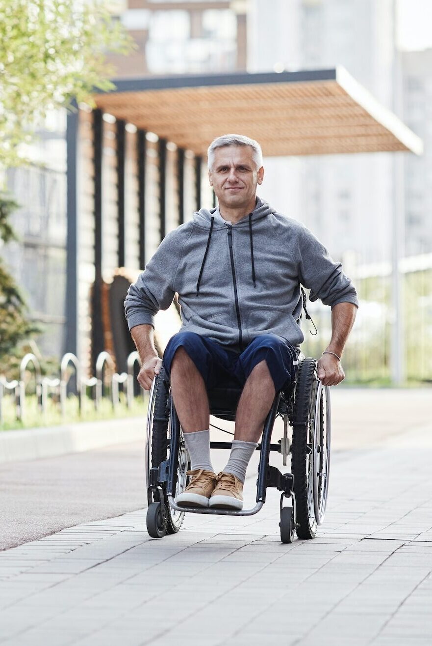 Man in wheelchair walking outdoors