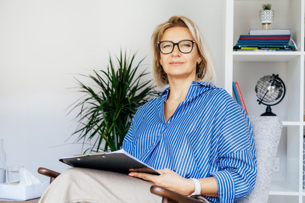 Portrait of smiling 50's stylish, confident mature businesswoman, middle aged company ceo director, experienced senior female professional, business coach team leader in modern office. Female leader